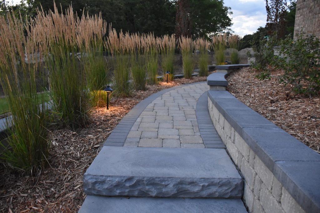Stone and brick walkway. Outlines with landscape lighting.