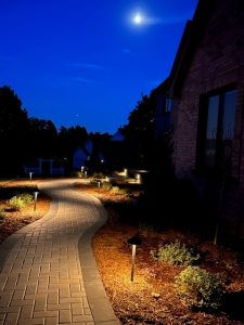 Photo of a new paved walkway with lighting along the path. 
